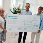 Ieuan Griffiths - right - presents cheque to representatives of Ty Bryngwyn Hospice