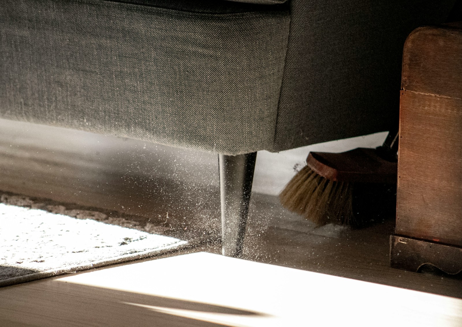 a close up of a chair with a broom on the floor