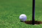 white golf ball on green grass field during daytime