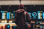 person looking up to the flight schedules