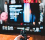 person holding black remote control
