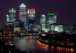 Beautiful nighttime view of Canary Wharf, London, with reflections on the River Thames.