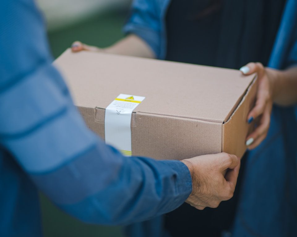 person giving brown box