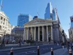 a large building with columns and a statue in front of it with Royal Exchange, London in the background