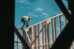 construction worker in hard hat on building frame