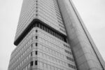 A low-angle view of a modern skyscraper with a grid of windows
