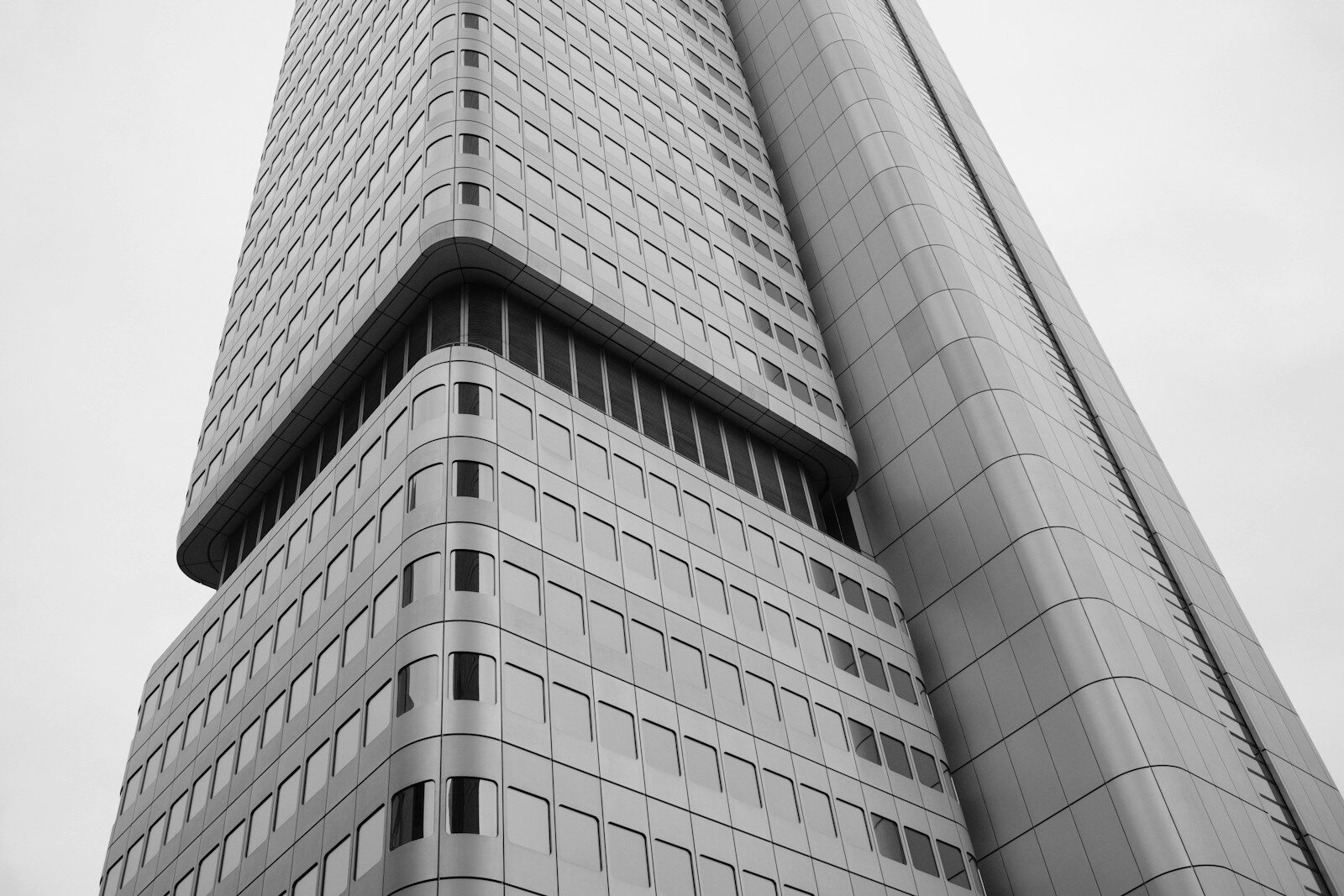 A low-angle view of a modern skyscraper with a grid of windows